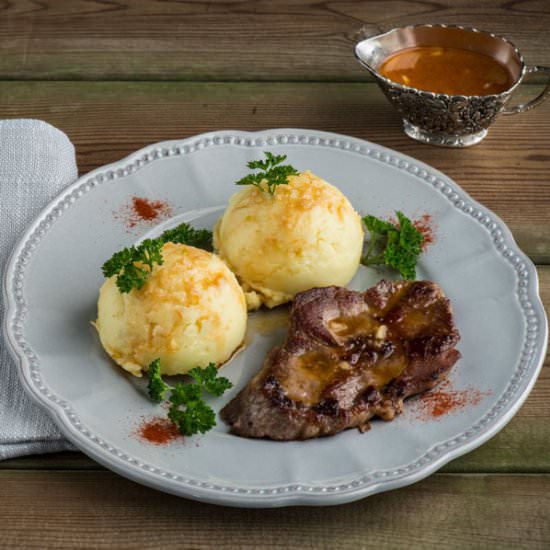 Pork steak with smashed potatoes