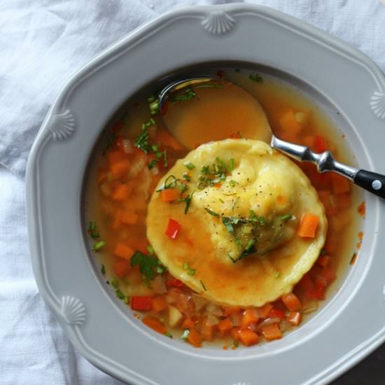 Shrimp ravioli in saffron broth