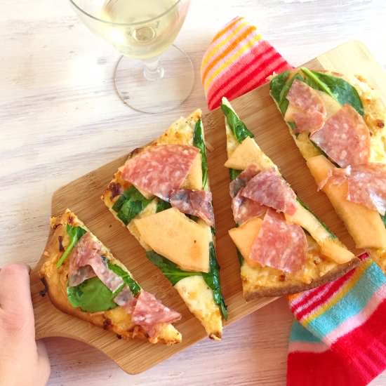 Melon, salami, and spinach pizza