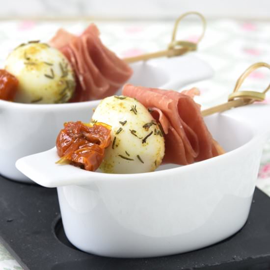 Quail egg with ham and thyme