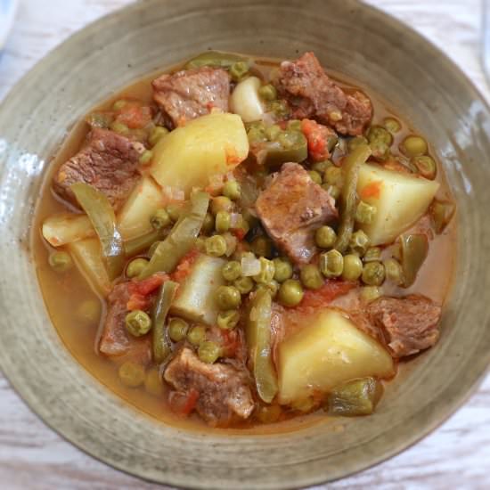 Stewed meat with potatoes and peas